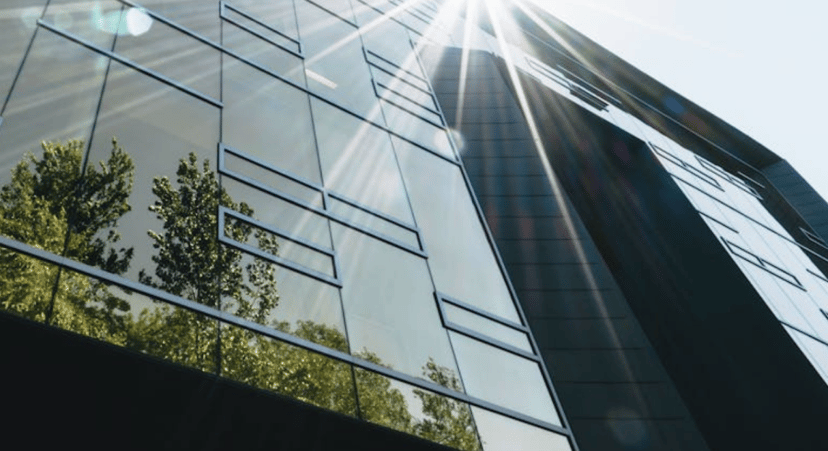 a glass building reflecting light